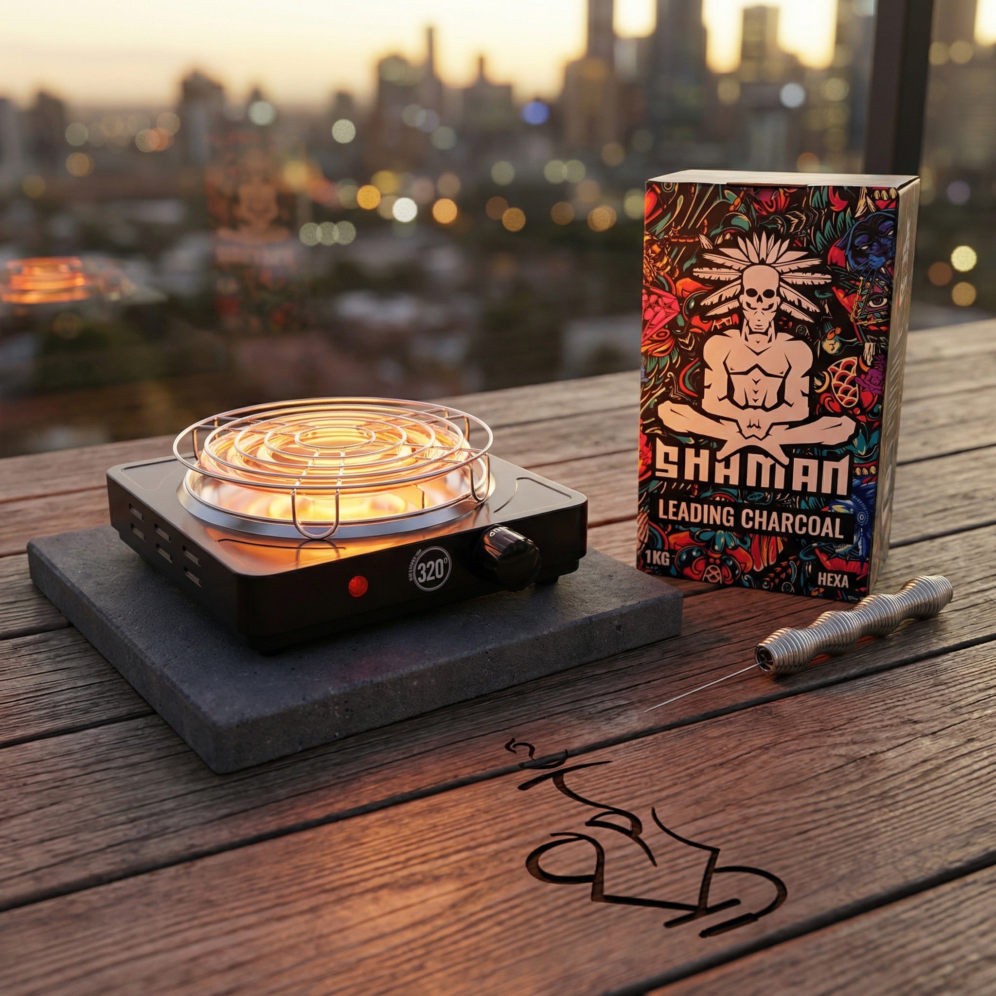 The 320 electric charcoal burner glowing on a dark concrete paver beside a Shaman Hexa coconut charcoal box and Smoothpoke poker on a Melbourne balcony at golden hour, from The Premium Way.