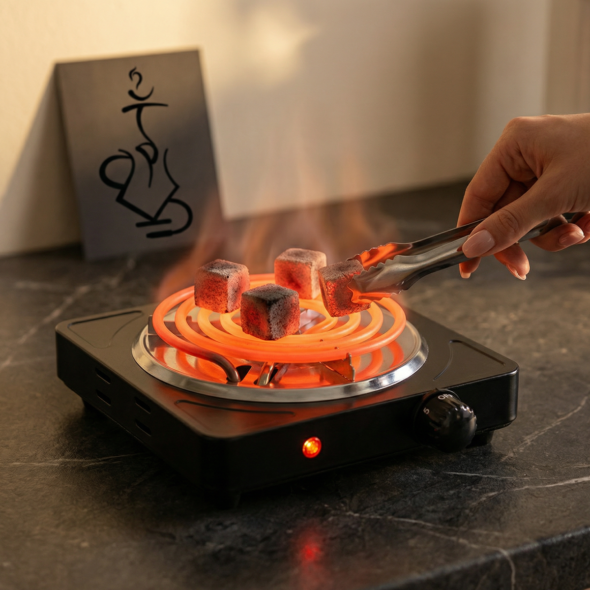 Hot plate with glowing orange coils and marshmallows being roasted on a dark surface., image 2 of 9