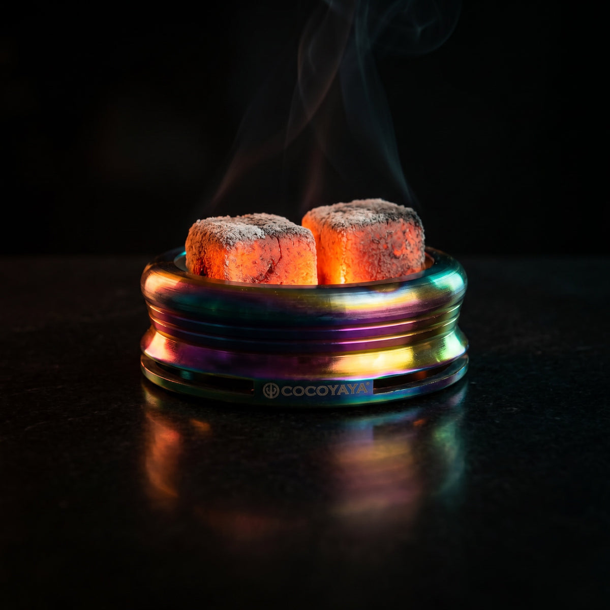 Cocoyaya Pro 5 Rainbow HMD with two lit coals on polished black surface, smoke ribbon, The Premium Way, image 2 of 5