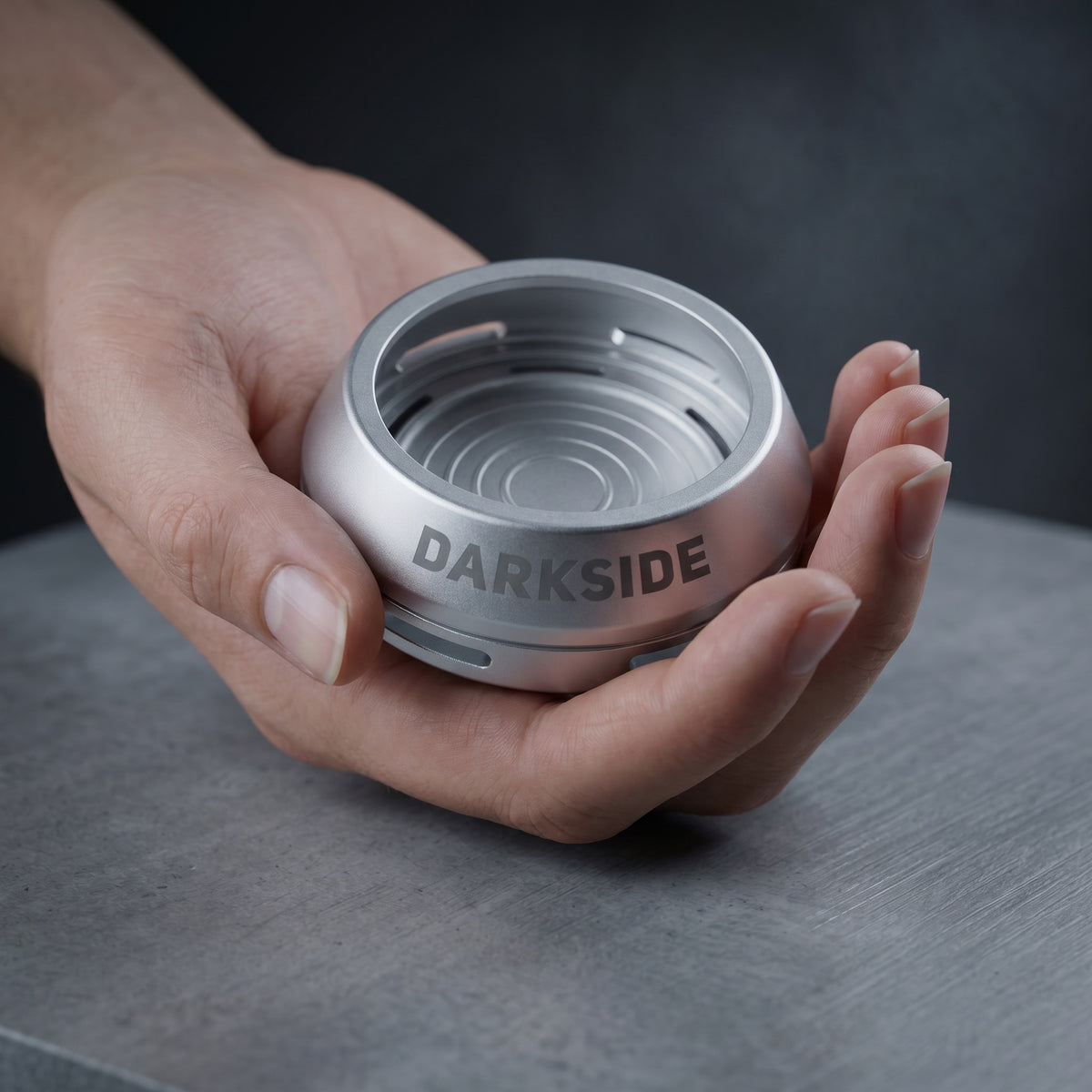 Darkside D-Heater Silver palm-sized HMD cradled in an open hand showing compact size, image 4 of 21