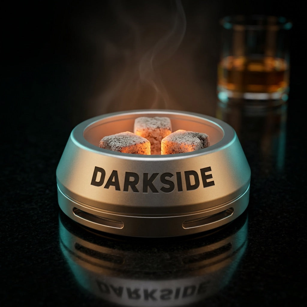 Darkside D-Heater Silver HMD with three lit coconut coals on polished black stone in premium lounge, image 2 of 21