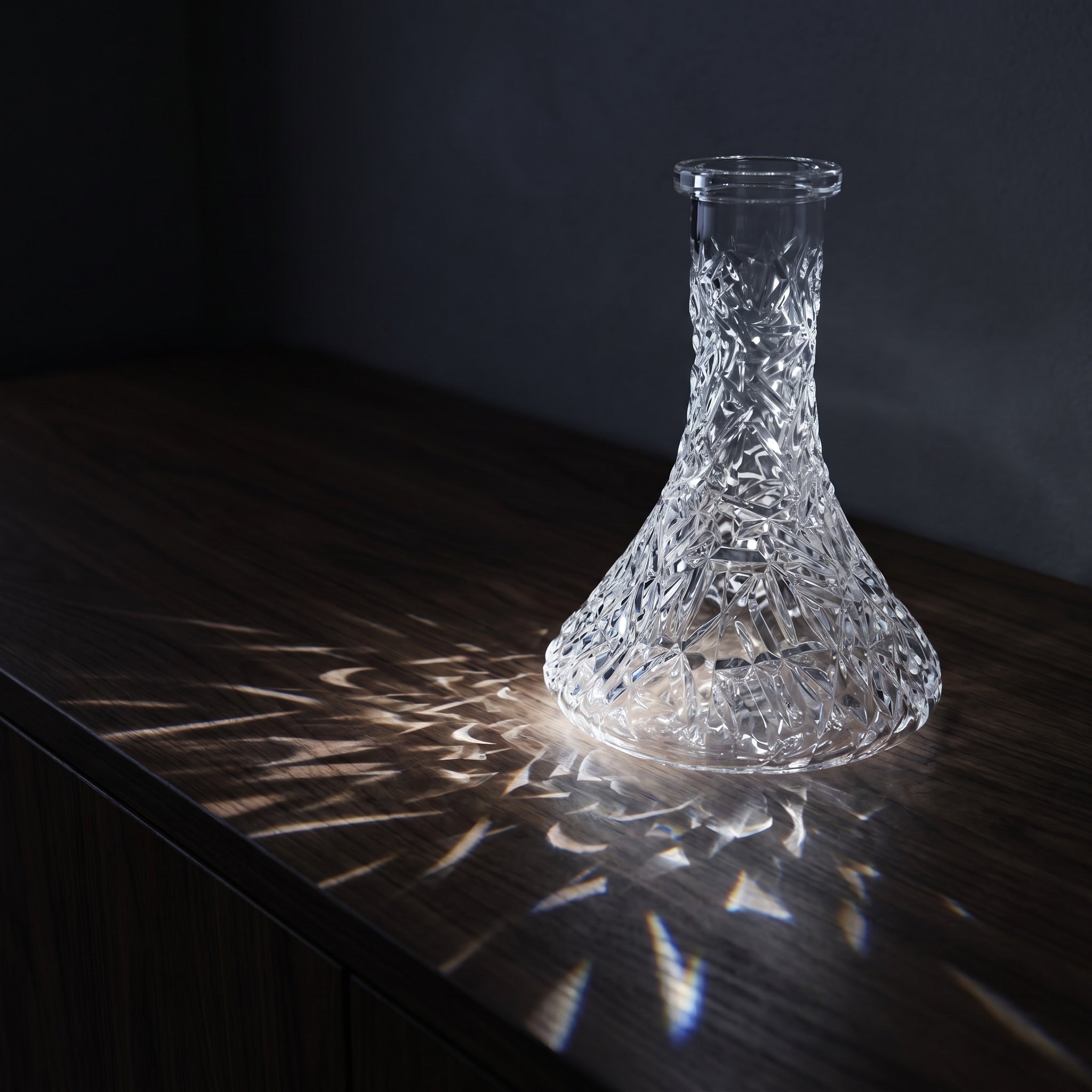 Essentials Crystal-Cut Clear Russian shisha vase on dark walnut credenza, light refracting through the cut pattern across the surface