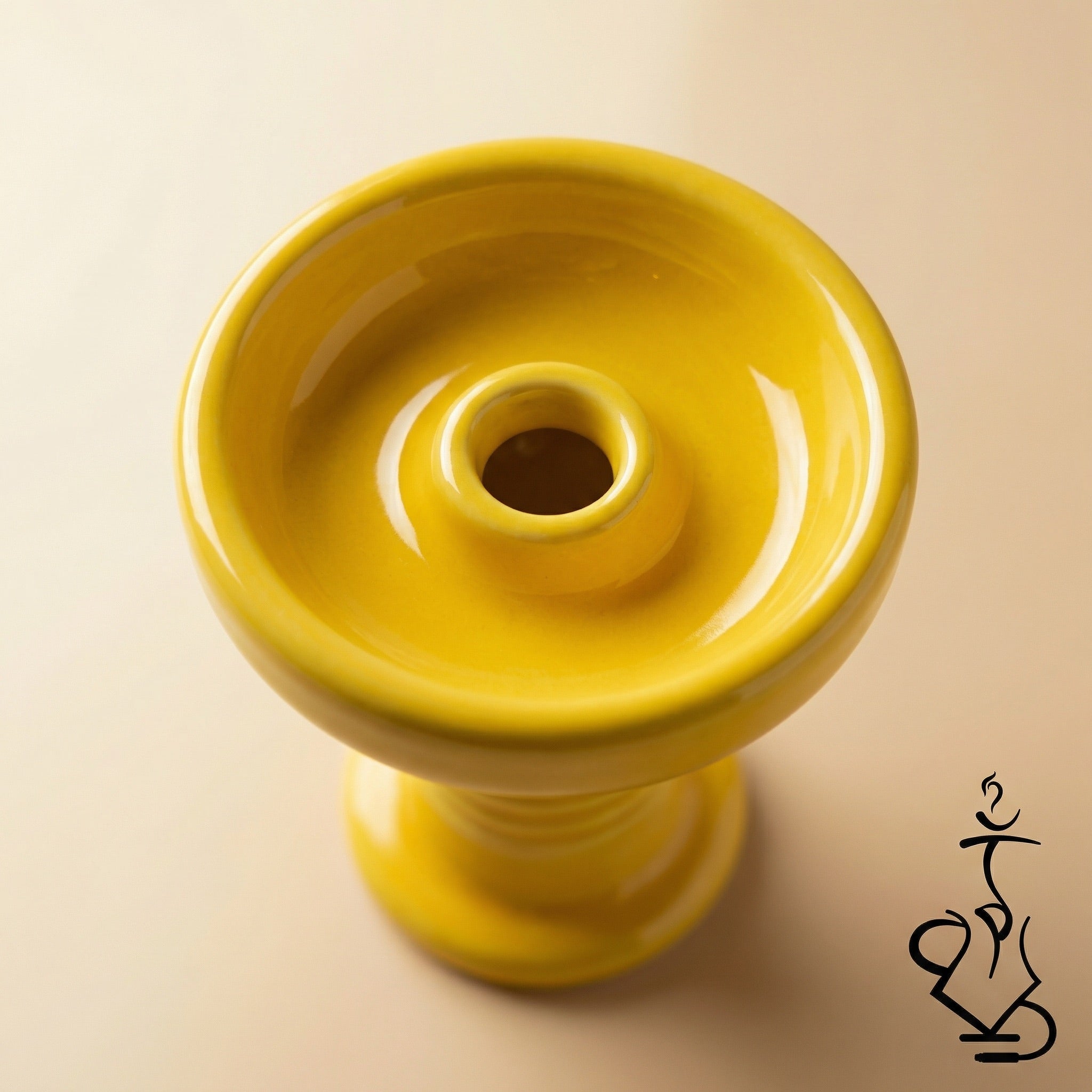 Top-down macro view of the Essentials Glazed Phunnel Bowl showing the glossy yellow glaze, concave basin, and central spire hole in sharp detail.
