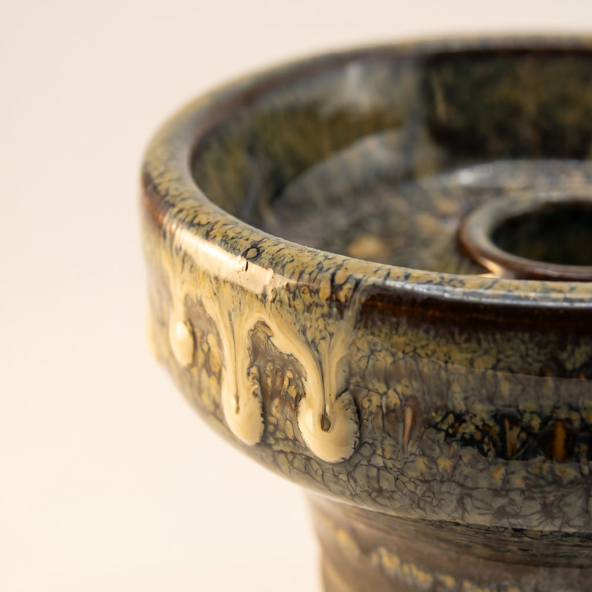 Close-up macro of Sentinel glaze on Knight Phunnel Bowl showing cream drip tongues over olive crystalline, image 4 of 7