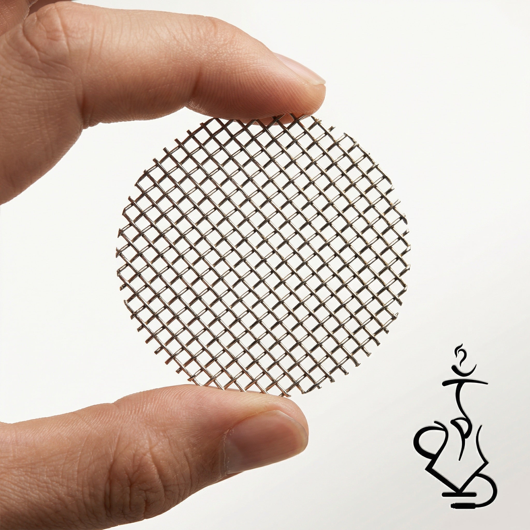 A hand holding the Essentials stainless steel mesh bowl insert between thumb and forefinger, showing the approximate 7 cm diameter and fine food-grade woven stainless wire weave.