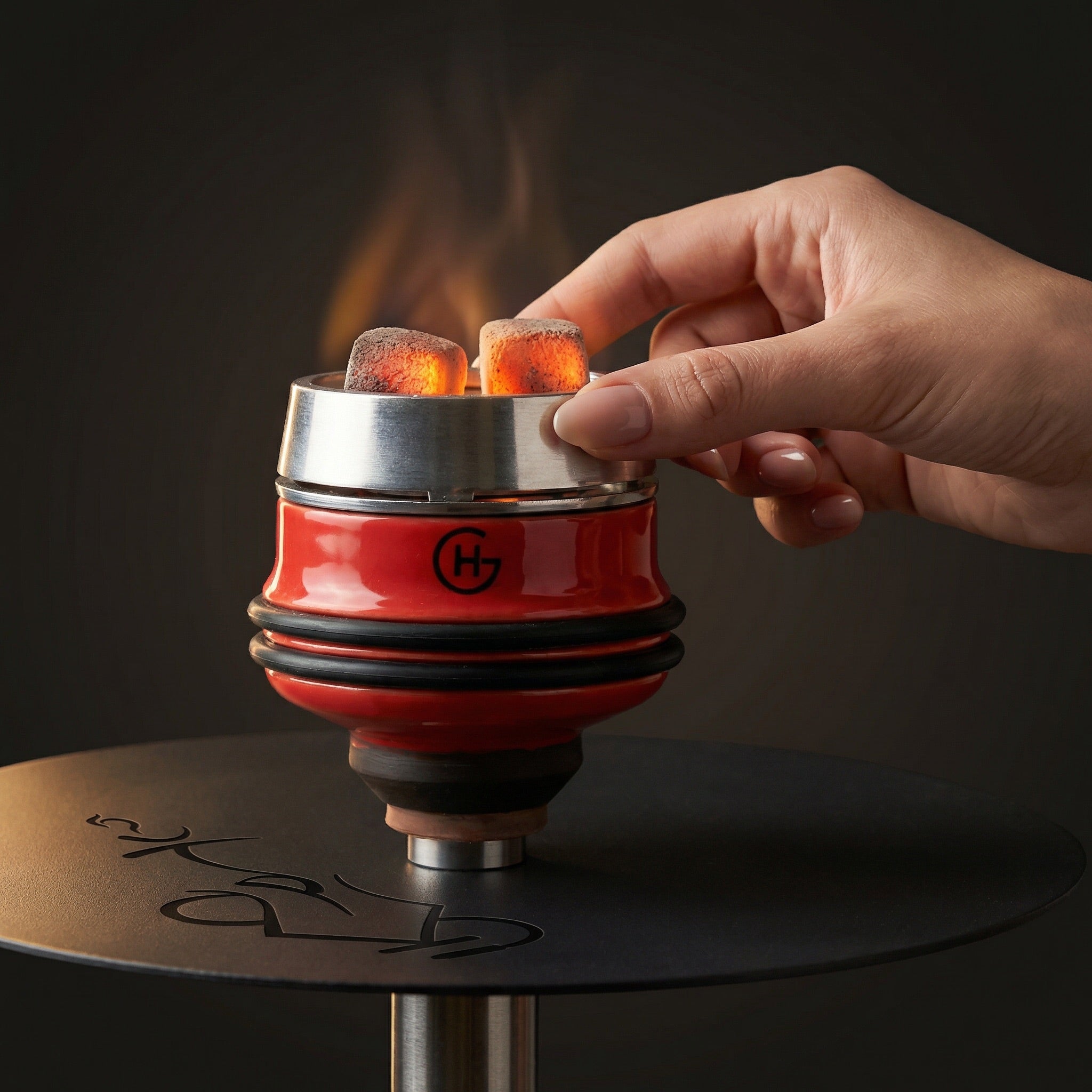Geometry Short Phunnel Bowl in red mounted on a hookah with heat management device and glowing coals, hand adjusting the HMD mid-session.