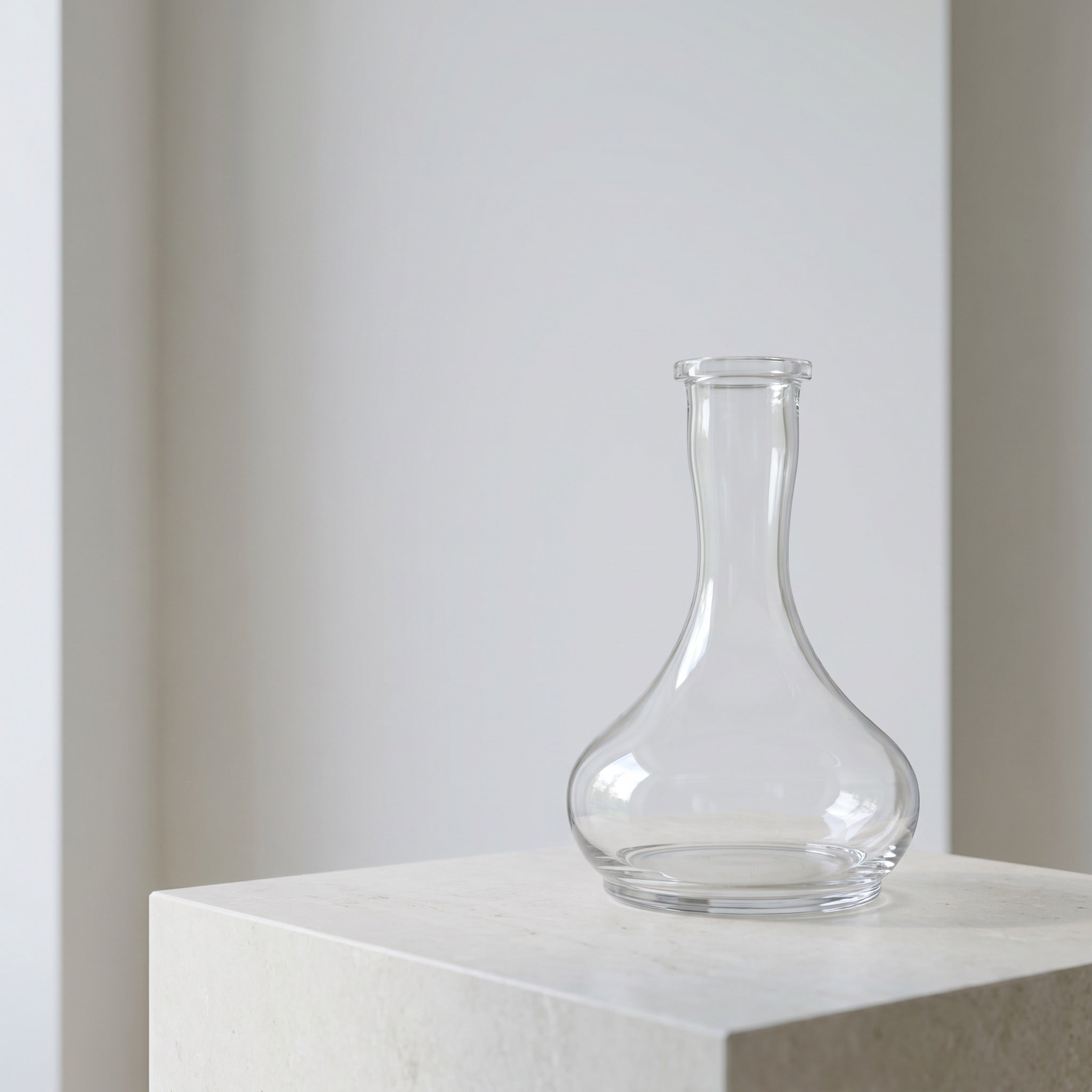 Hookah Tree Tear Drop clear glass shisha vase on pale limestone plinth in soft architectural daylight