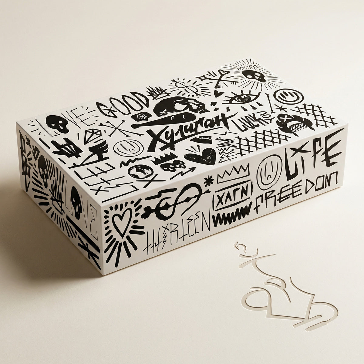 Hooligan presentation box, matte white printed gift box covered in the brand's signature hand-drawn black graffiti artwork, shown closed at a three-quarter angle., image 11 of 25