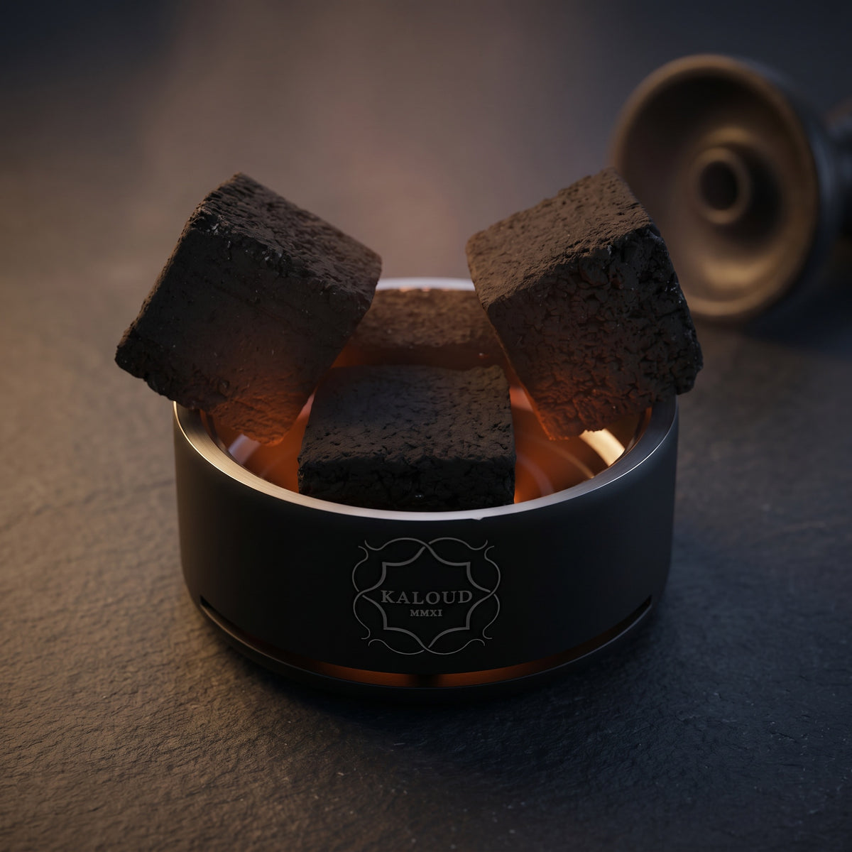 Kaloud Lotus I+3 Niris Black HMD loaded with four coconut coals, warm internal glow, slate surface, image 2 of 10