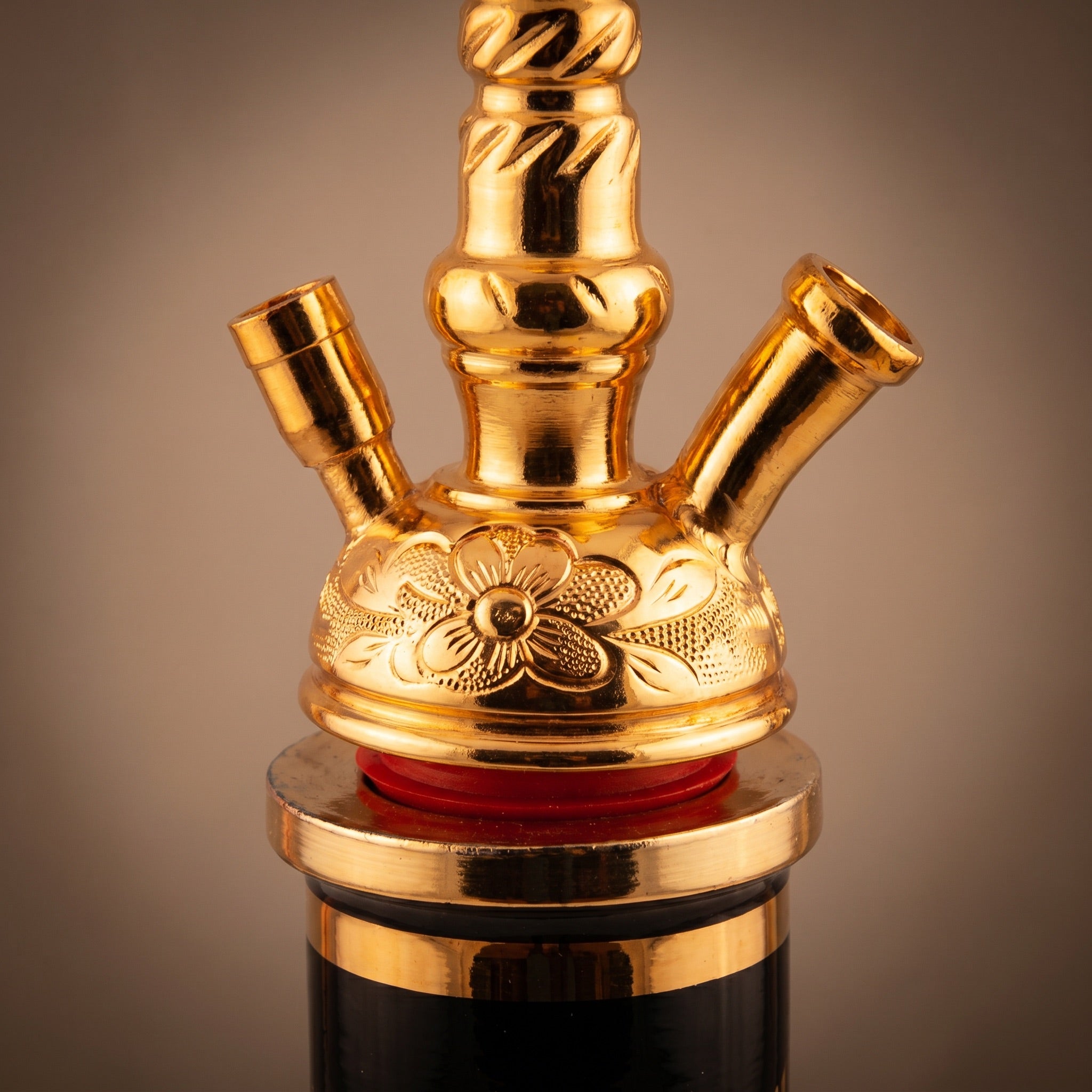 Khalil Mamoon Skinny Gold port hub macro detail showing raised floral ornamentation and twin angled gold ports