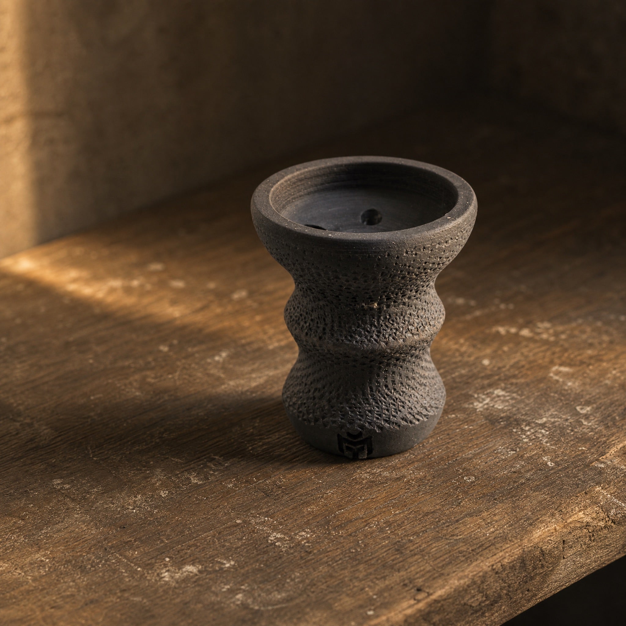 Handmade MIT Luxury DarkStar Turkish bowl on aged workshop bench in afternoon light, unglazed stoneware