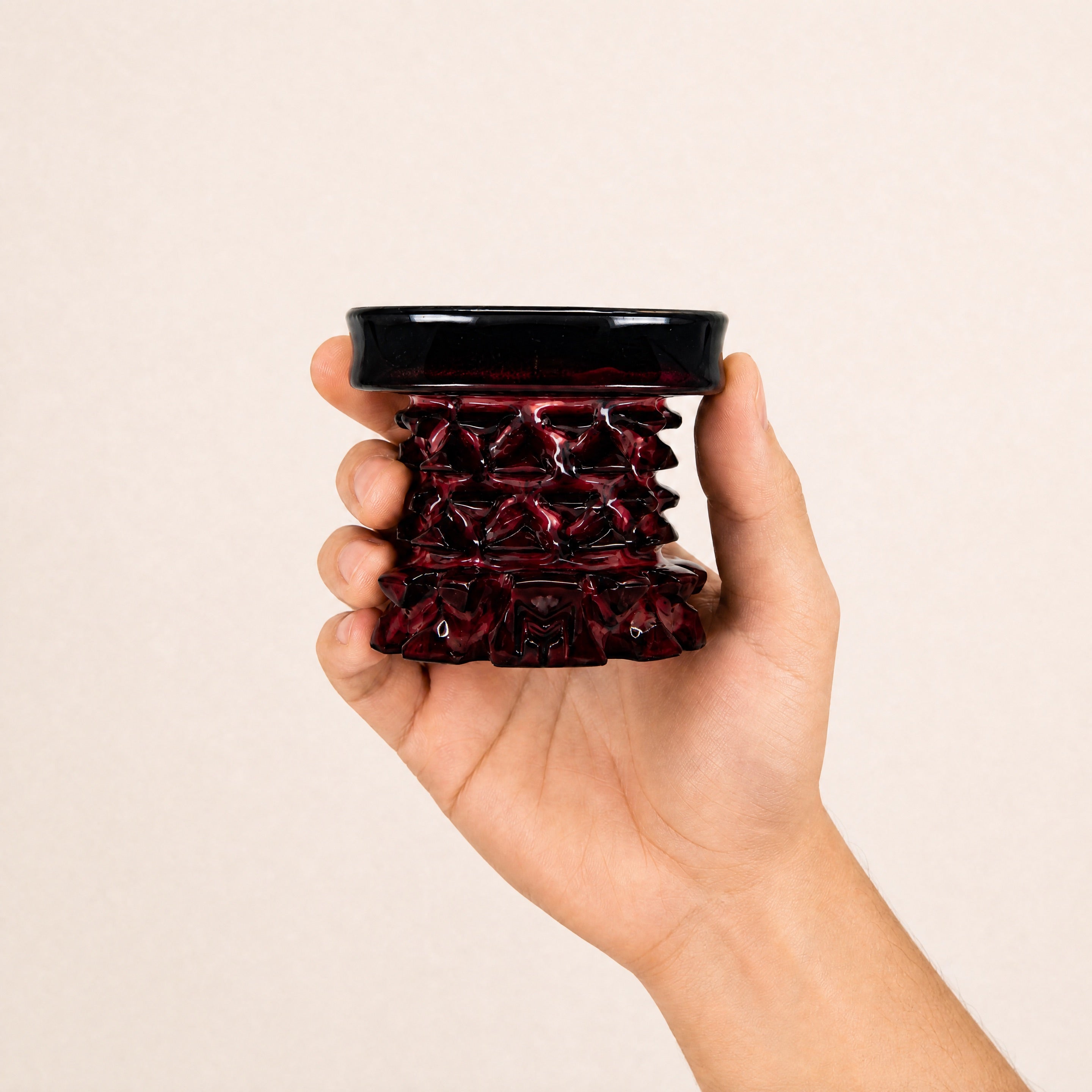 MIT Luxury Mitovation V2 Ruby bowl held in hand, showing 80mm scale and oxblood red glaze relief