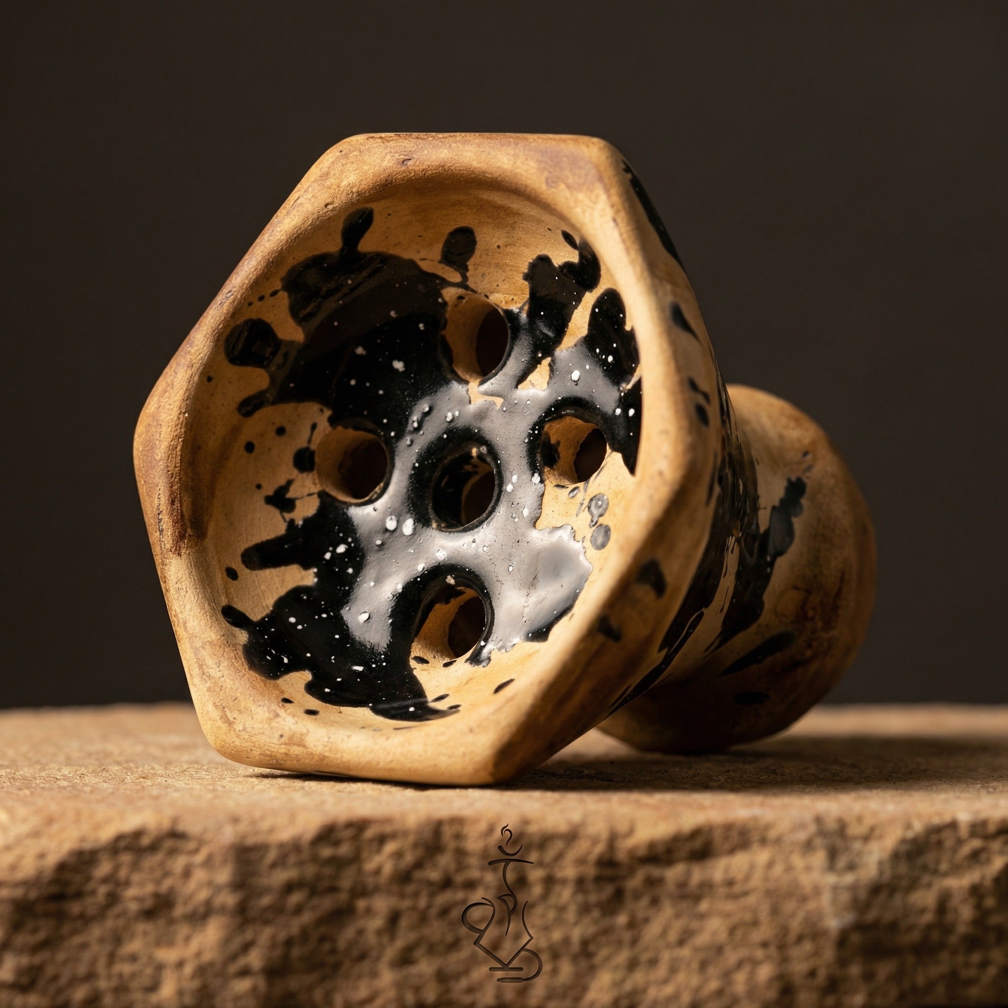 Moon Grand Cap bowl interior showing traditional Egyptian hole pattern and black splatter glaze on handmade clay, macro detail view