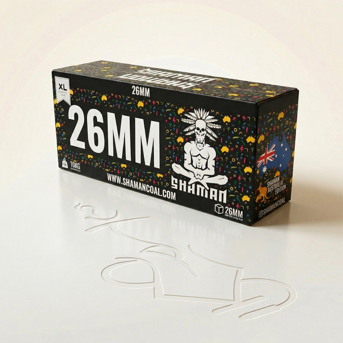Shaman 26mm coconut charcoal 10kg master box at a three-quarter angle showing the front face and Australia Edition side panel in a professional studio setting., image 6 of 15