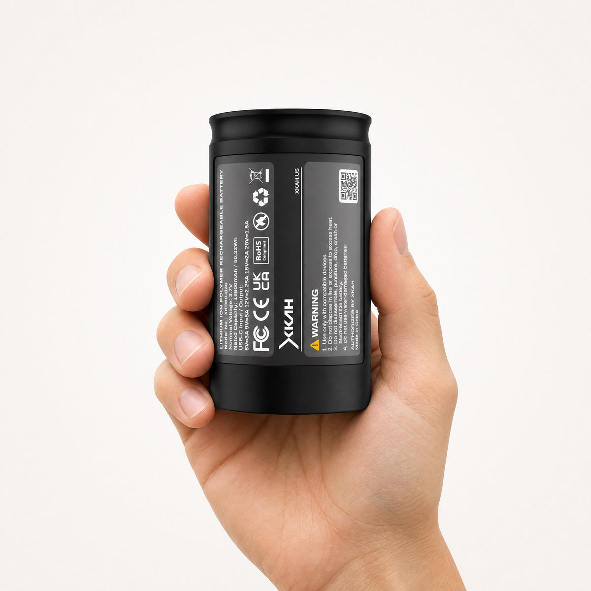 XKAH Pro replacement battery held upright in one hand, swap-ready, showing true size in hand., image 4 of 9