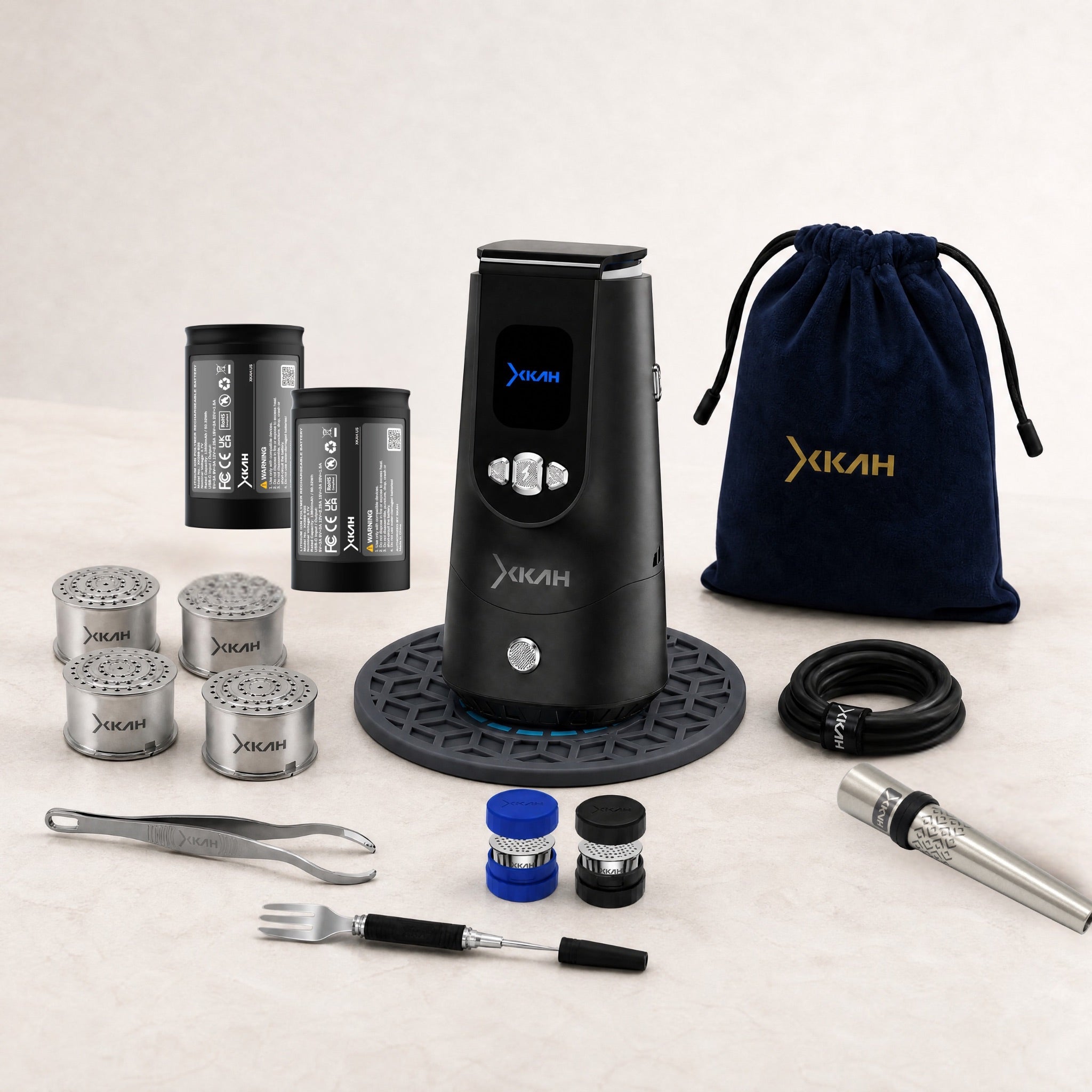 XKAH Pro Complete Kit displayed in full — eHMD on the 320° base mat with batteries, pods, mouthpiece, carry case and bag.
